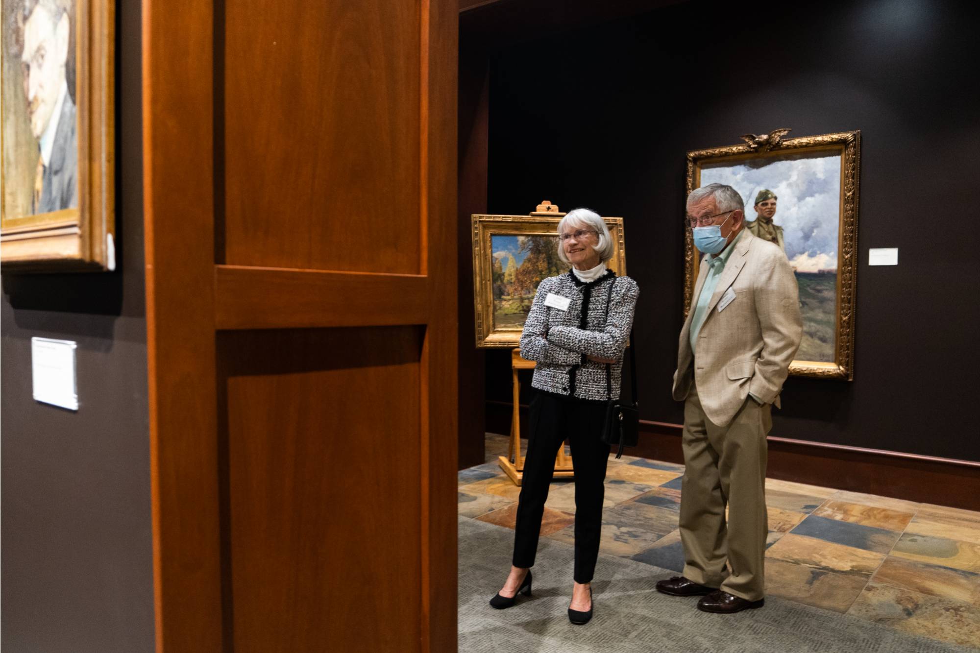 Ann and attendee looking at art